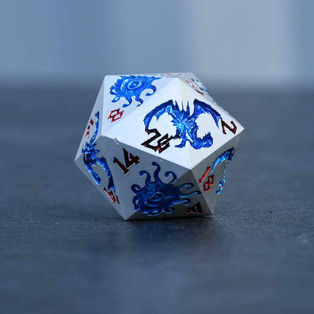 d20 dice that is silver metal dnd dice with blue monster patterns on them and red numbering