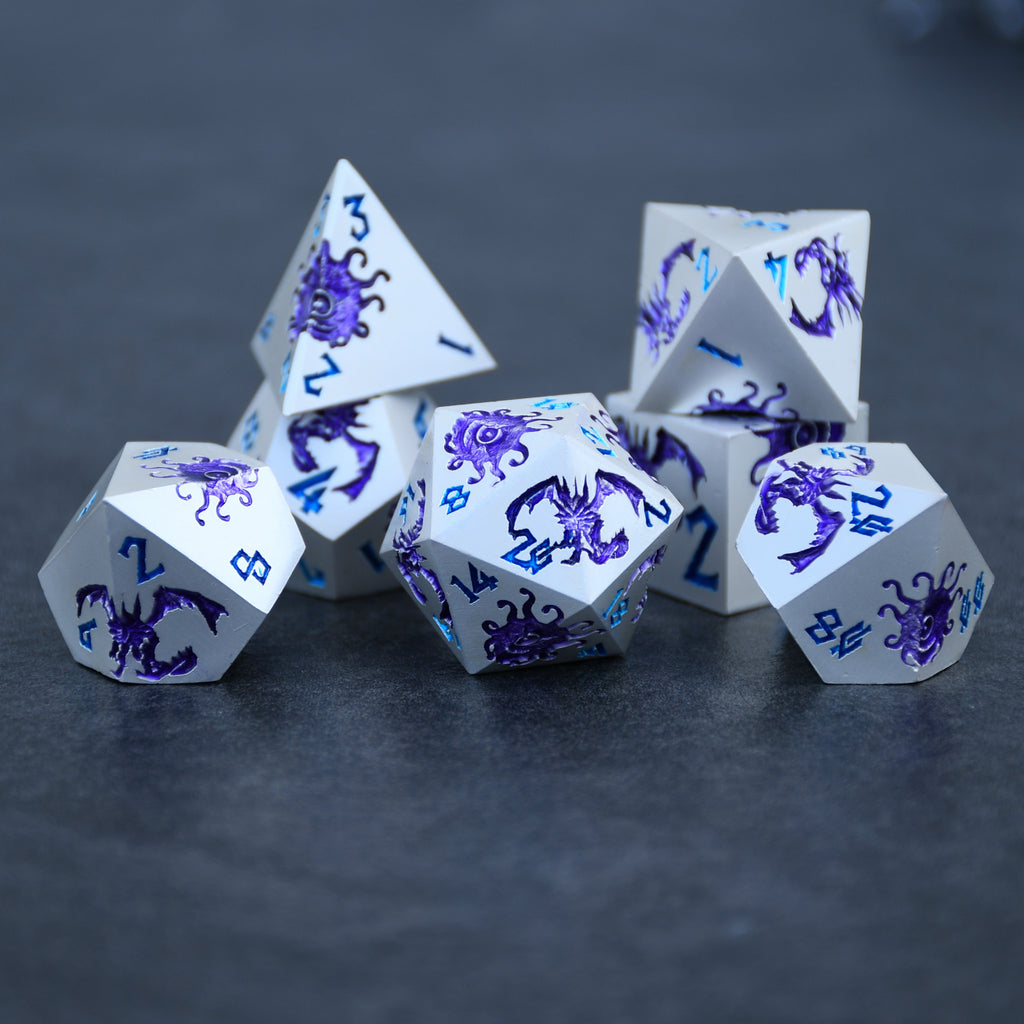 A set of silver metal dnd dice with purple monster patterns on them and blue numbering