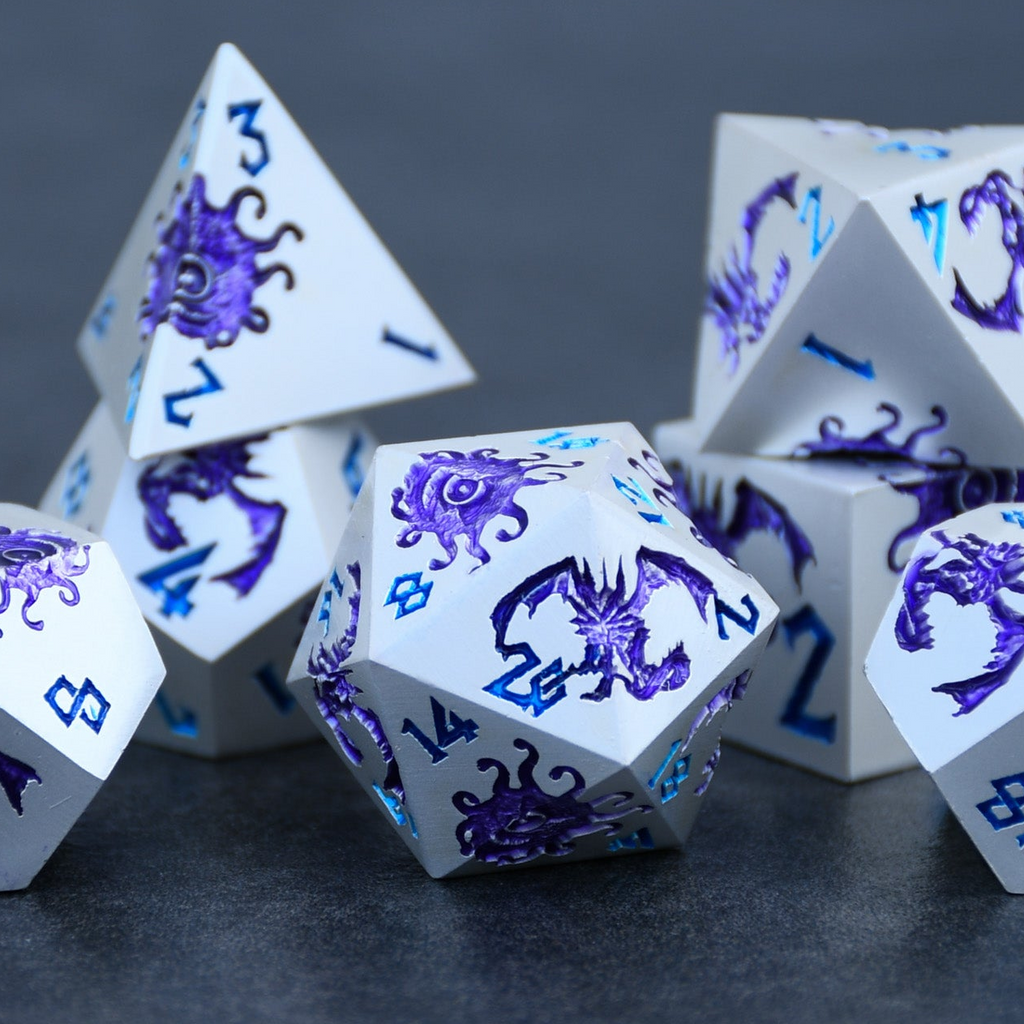 White polyhedral dice with blue and purple dragon designs on a dark surface