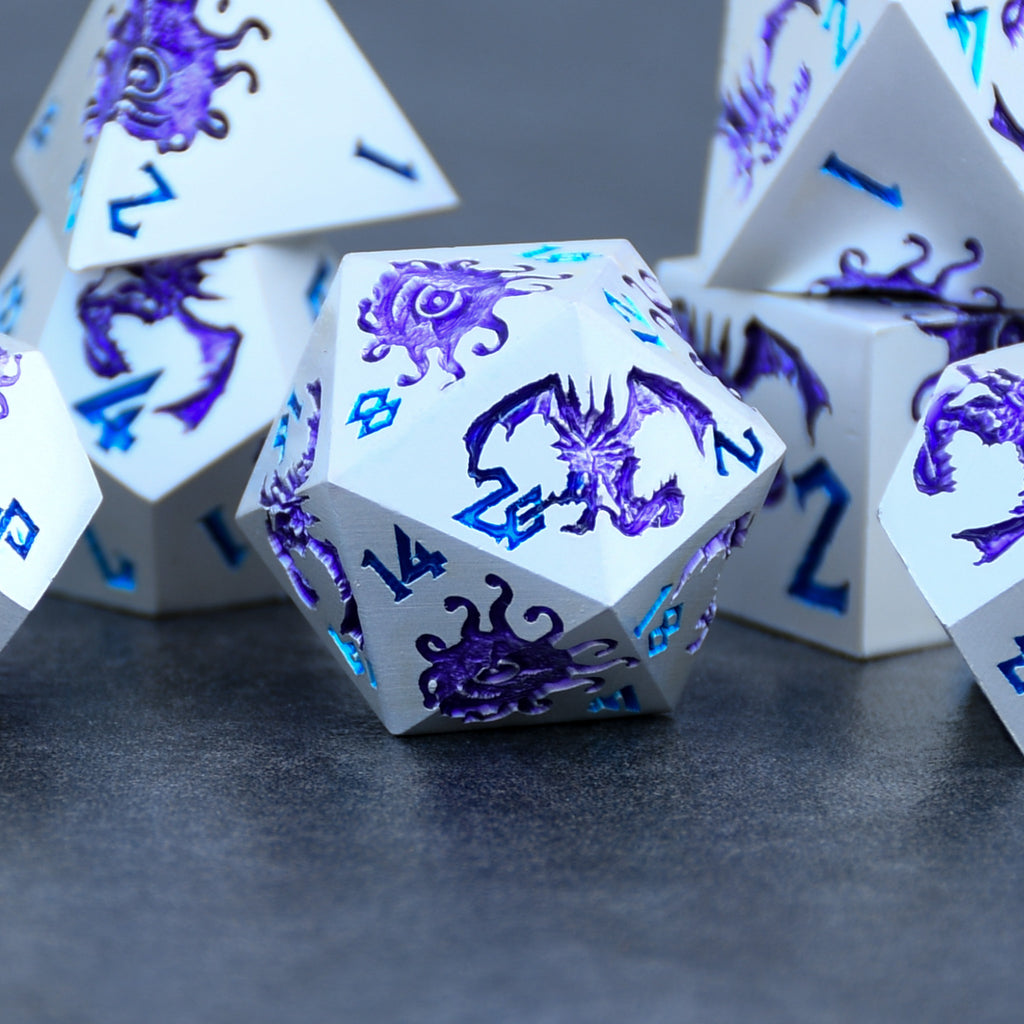 A set of silver metal dnd dice with purple monster patterns on them and blue numbering