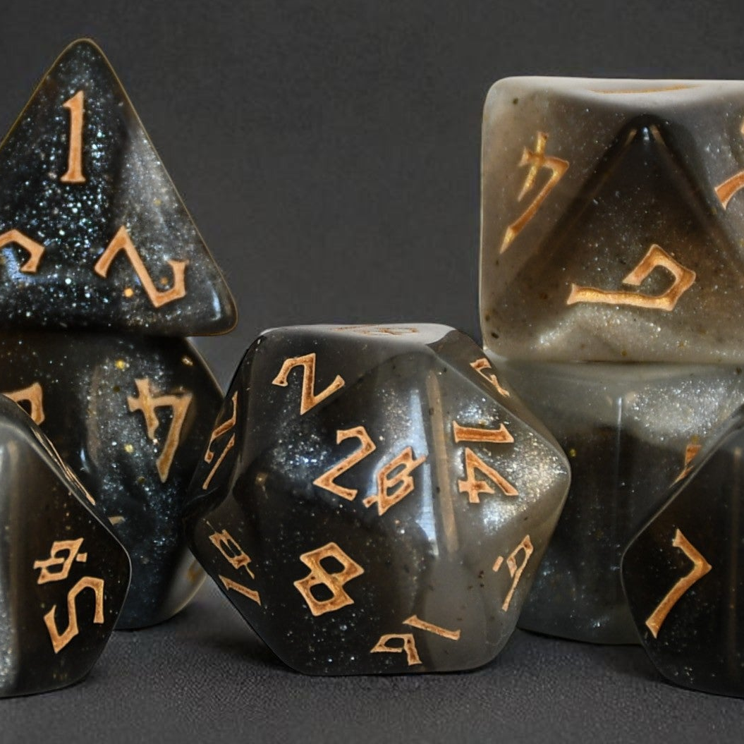 Black polyhedral dice with gold numbers on a dark background