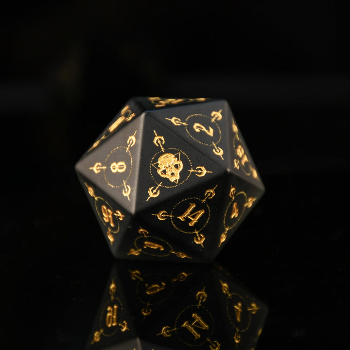 Black polyhedral dice with gold numbering and symbols on a black background