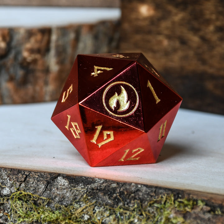 A red metal d20 spindown die with gold engraved numbers, displayed on a wooden surface.