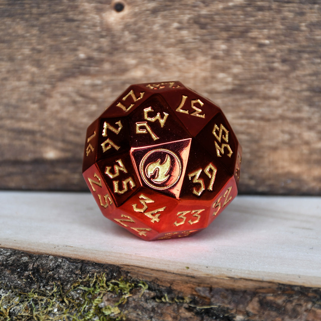 A single red metal spindown dice with engraved numbers and a symbol on one face, placed on a wooden surface.