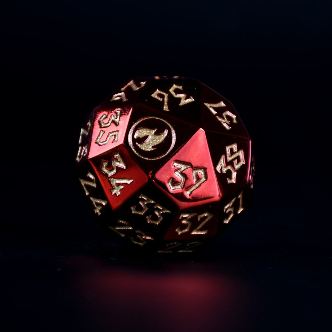 A single red metal spindown d40 dice with engraved numbers and a symbol on one face, placed on a wooden surface.