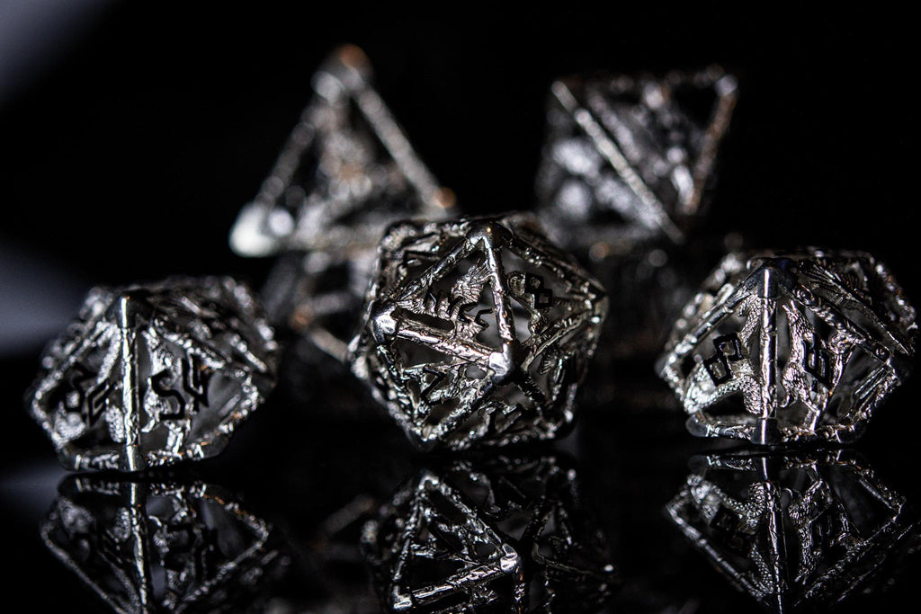 metallic polyhedral hollow dice with 'NYCC' branding on a black background
