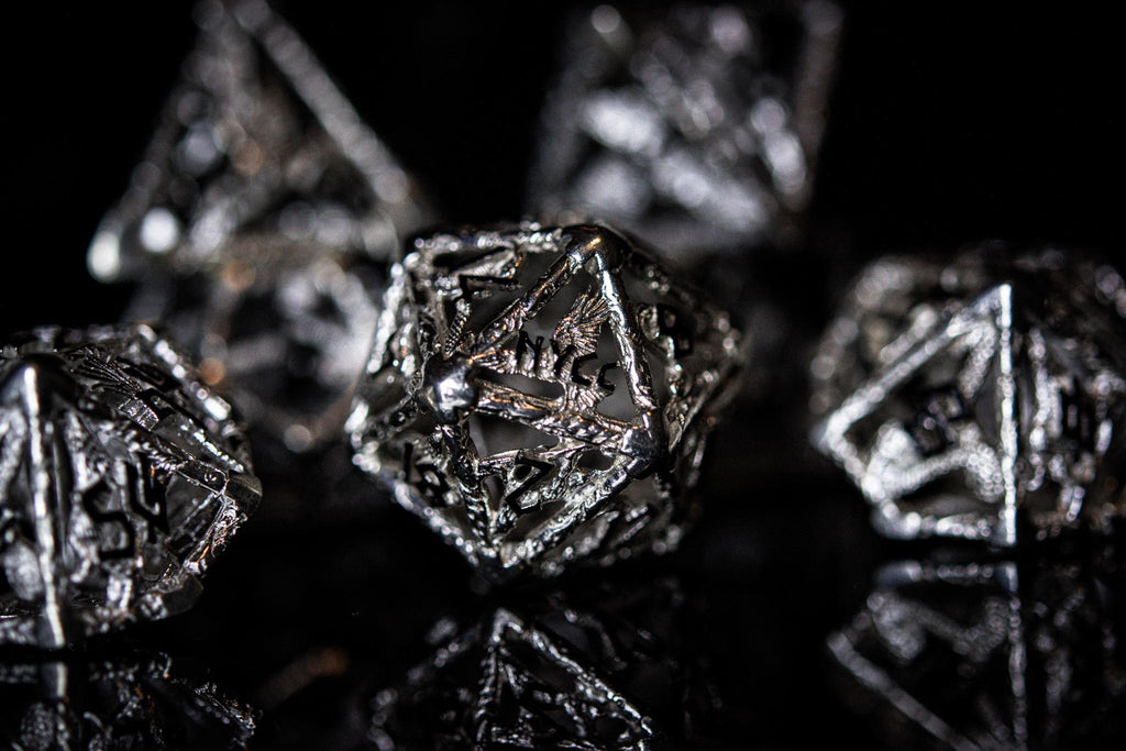 metallic polyhedral hollow dice with 'NYCC' branding on a black background