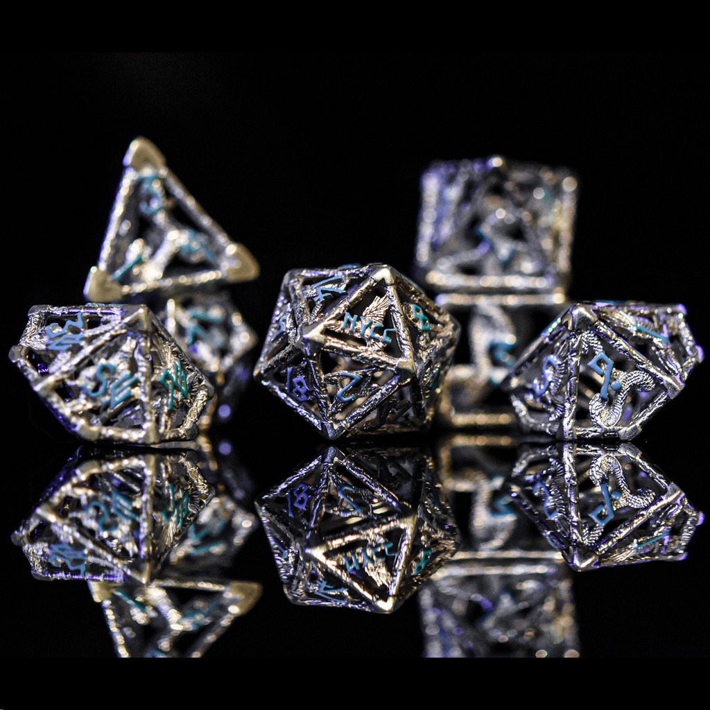 A set of sterling silver hollow dice with embossed numbers, displayed on a reflective surface.