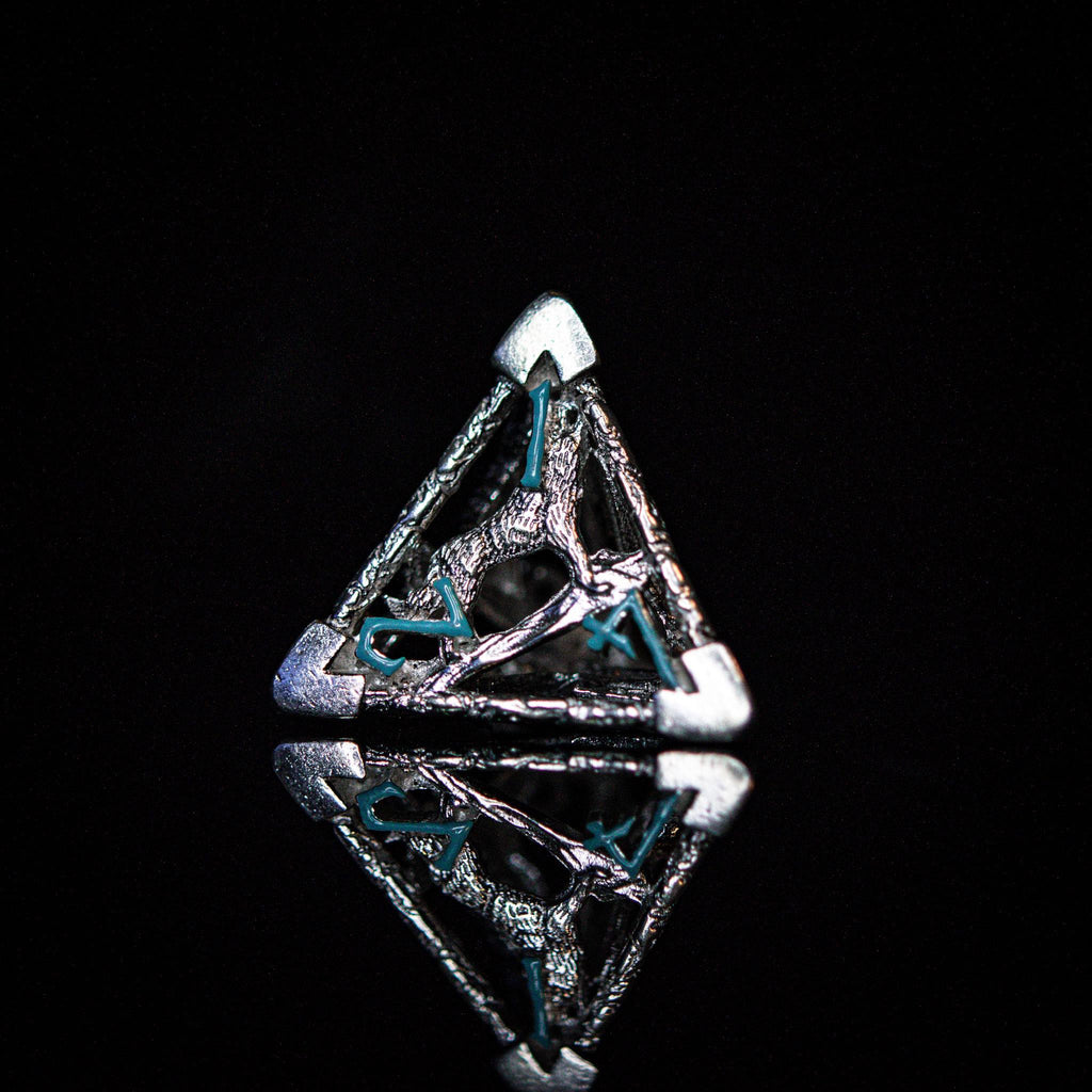 A set of sterling silver hollow dice with embossed numbers, displayed on a reflective surface.