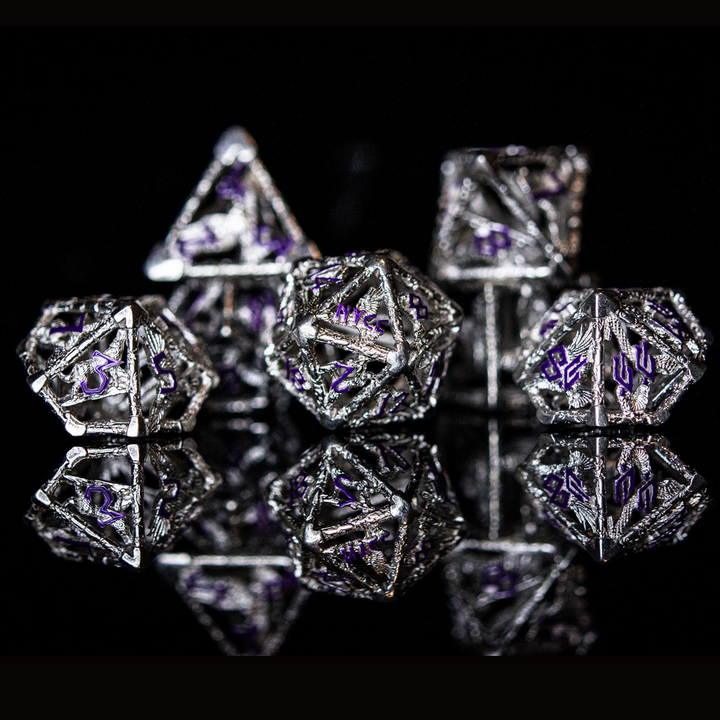 A set of sterling silver hollow dice with purple embossed numbers, displayed on a reflective surface.
