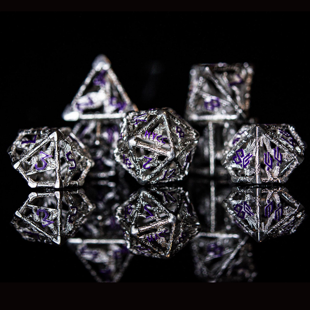A set of sterling silver hollow dice with purple embossed numbers, displayed on a reflective surface.