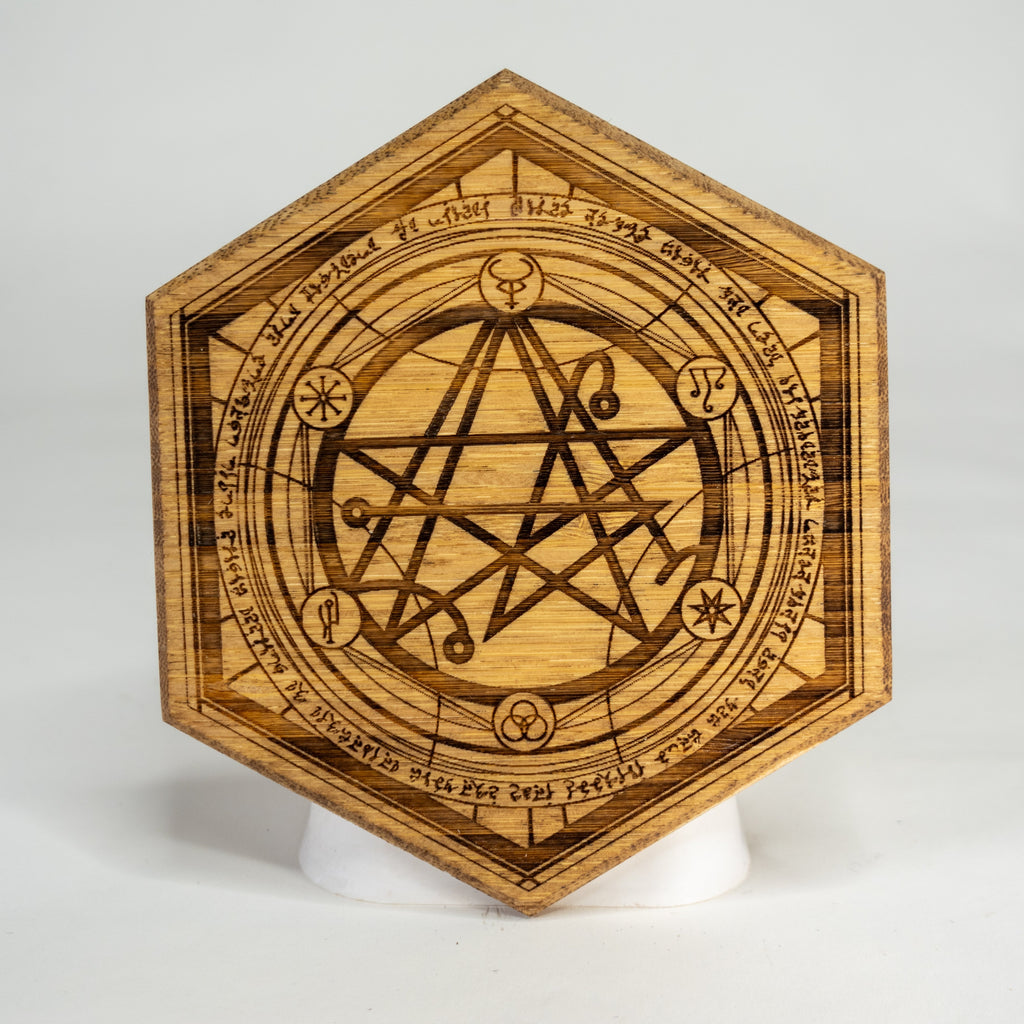 A hexagonal wooden magnetic art puck with intricate eldritch symbols and a pentagram design.