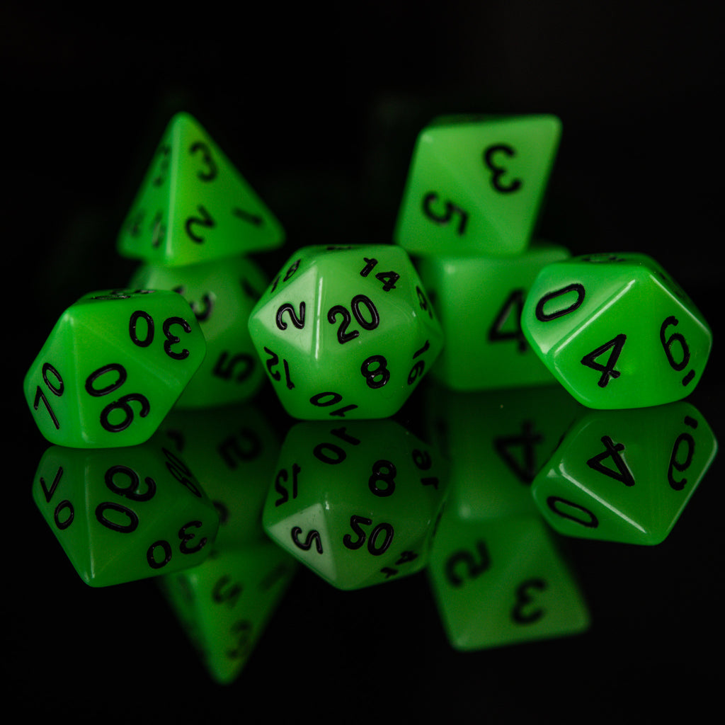 A set of neon green acrylic polyhedral dice with black numbers, including various shapes typical for role-playing games.
