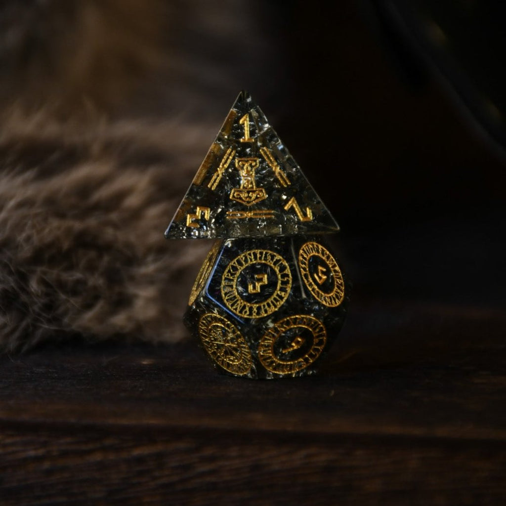 A set of black shattered glass polyhedral dice with Nordic designs