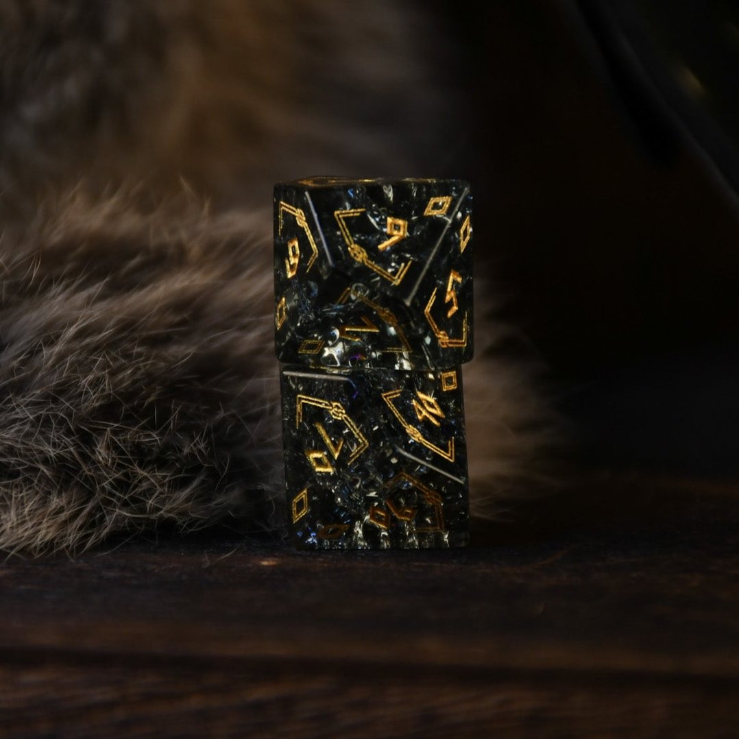 A set of black shattered glass polyhedral dice with Nordic designs