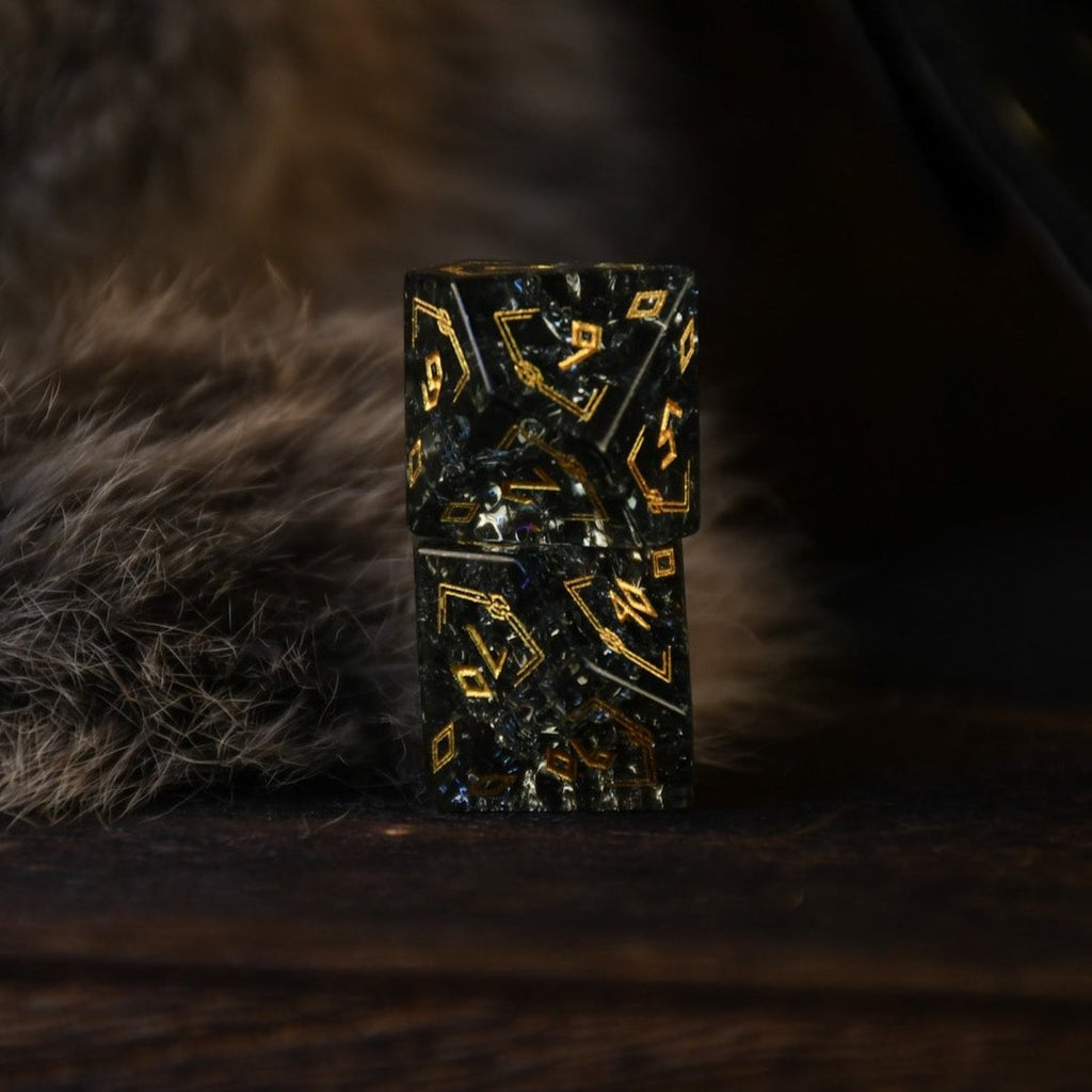 A set of black shattered glass polyhedral dice with Nordic designs