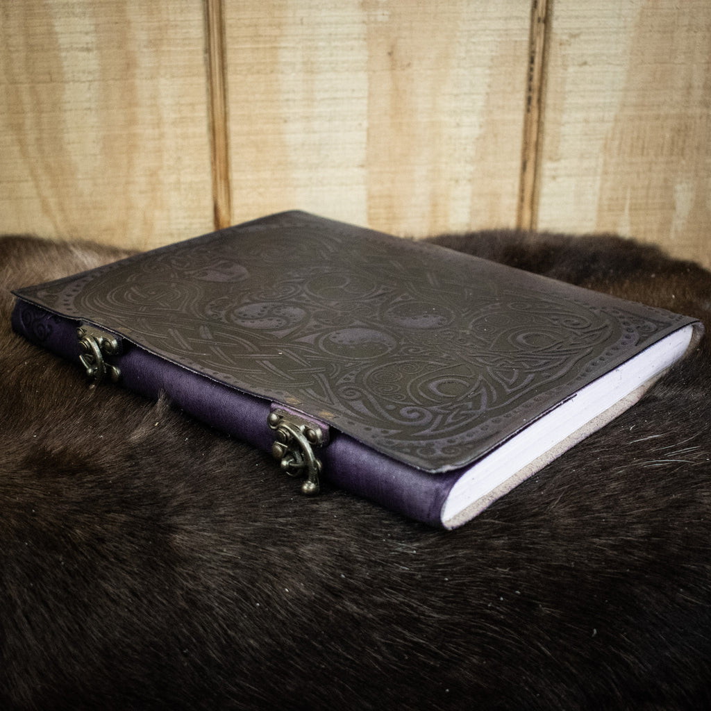 A leather sketchbook featuring an owl and woman