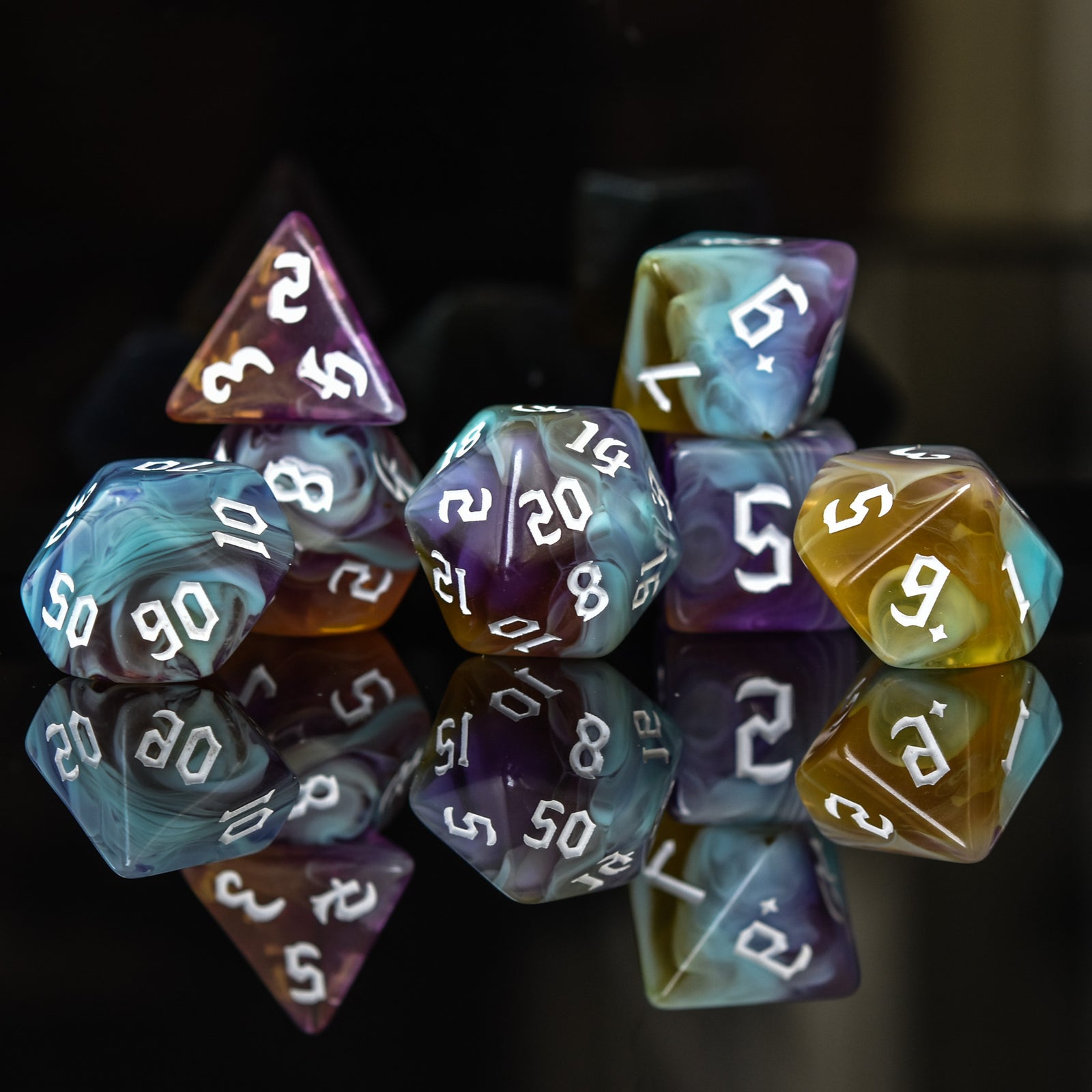 A set of multicolored acrylic dnd dice with engraved numbers, reflecting on a shiny surface.