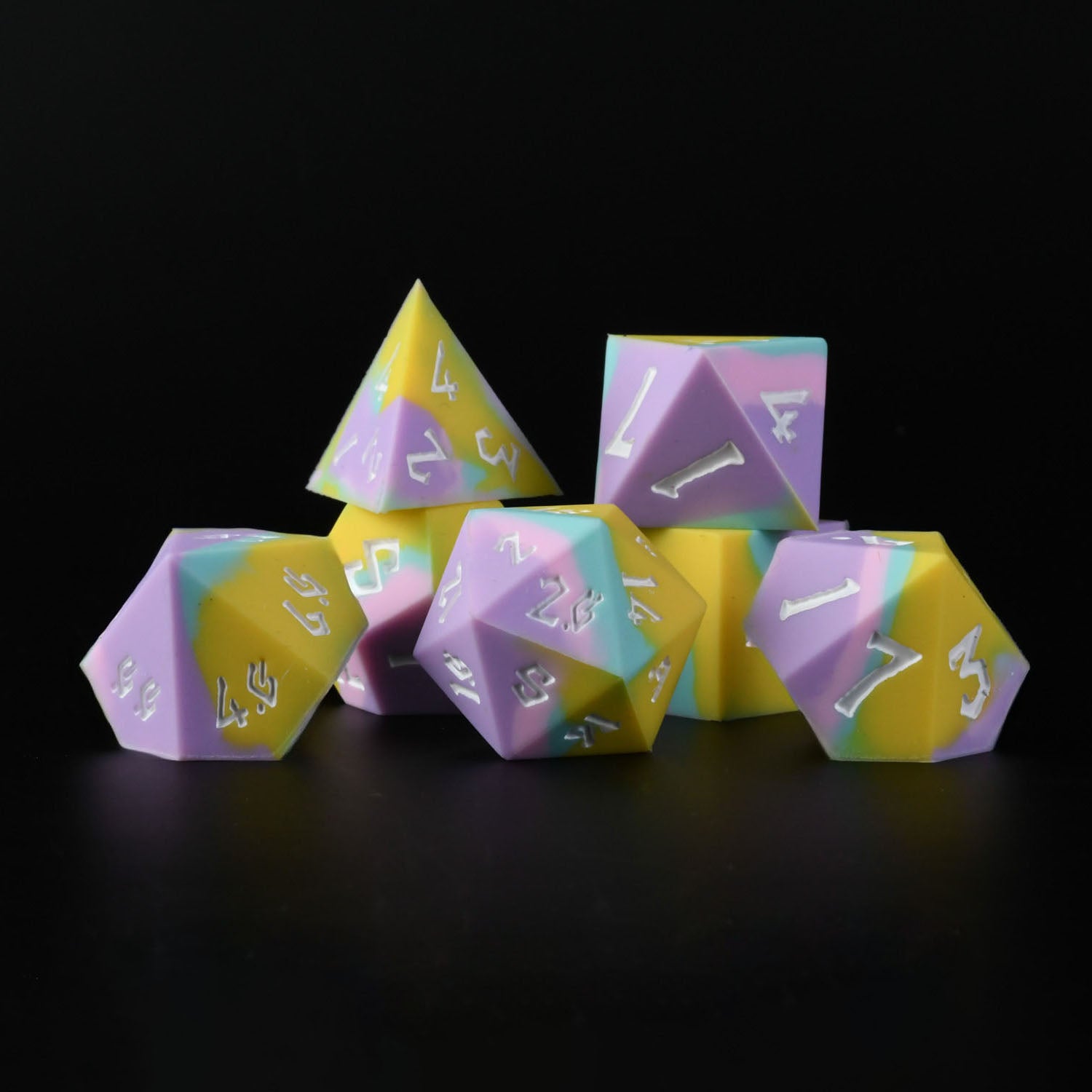 A set of silicone dice in pastel colors with engraved numbers, including various shapes such as a d4, d6, d8, d10, d12, and d20.