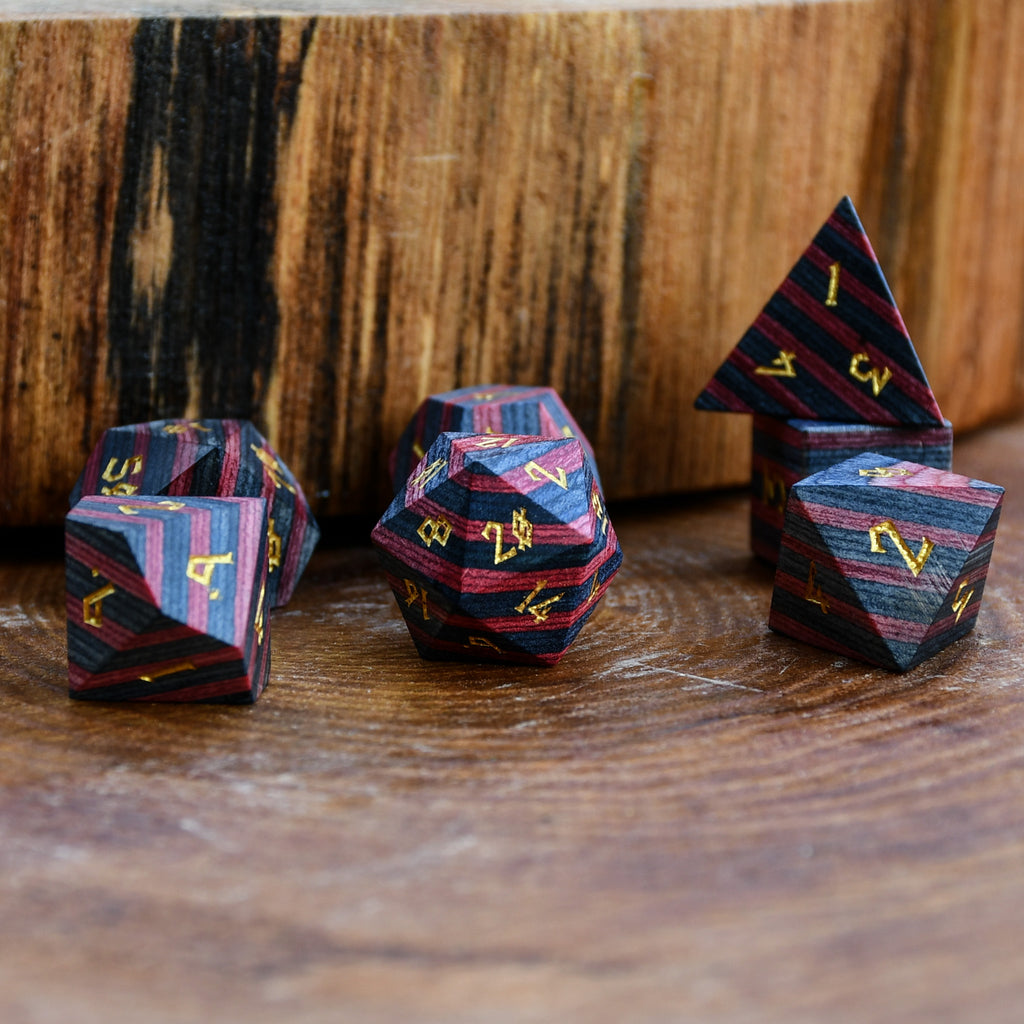 black and red wood dice with gold numbers for gaming