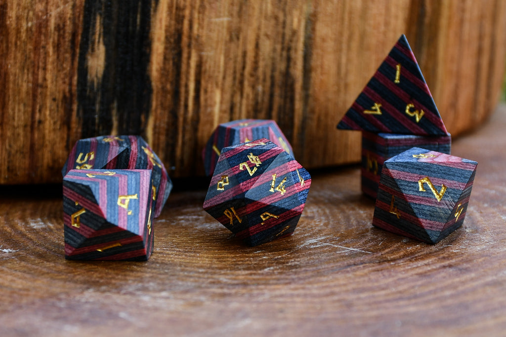 black and red wood dice with gold numbers for gaming