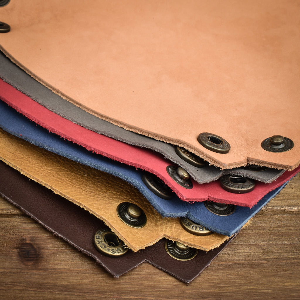 Pile of leather collapsible dice trays for tabletop gaming