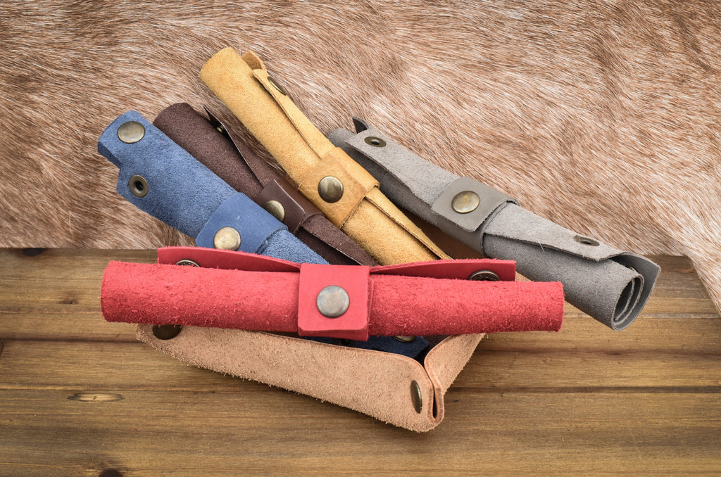 Pile of rolled up leather collapsible dice trays for tabletop gaming