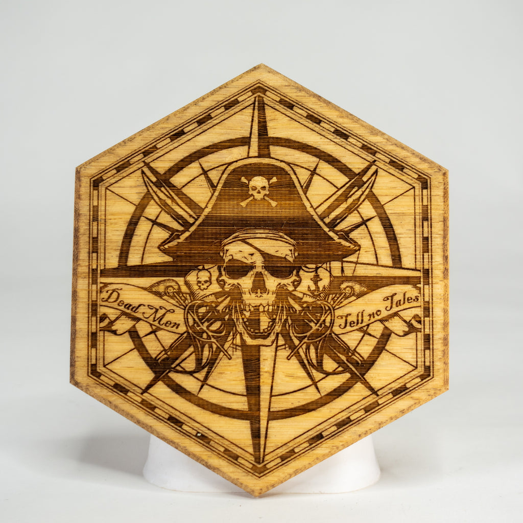 A wooden, hexagonal-shaped magnetic art puck with a pirate skull and treasure map design.