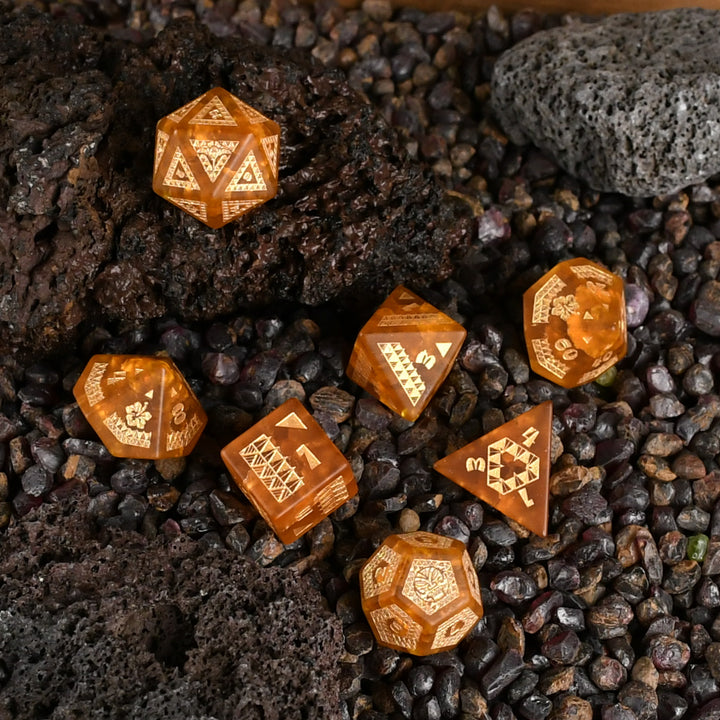 A set of Polynesian Lava Glass dice with Polynesian designs engraved on them.