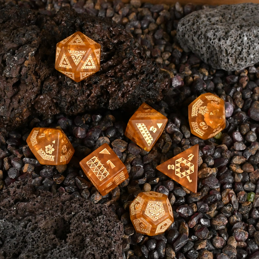 A set of Polynesian Lava Glass dice with Polynesian designs engraved on them.