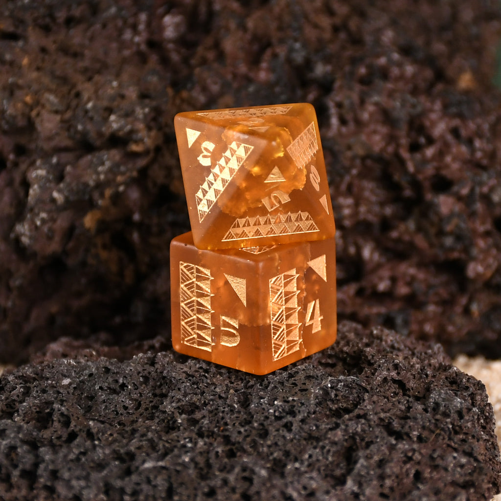 A set of Polynesian Lava Glass dice with Polynesian designs engraved on them.