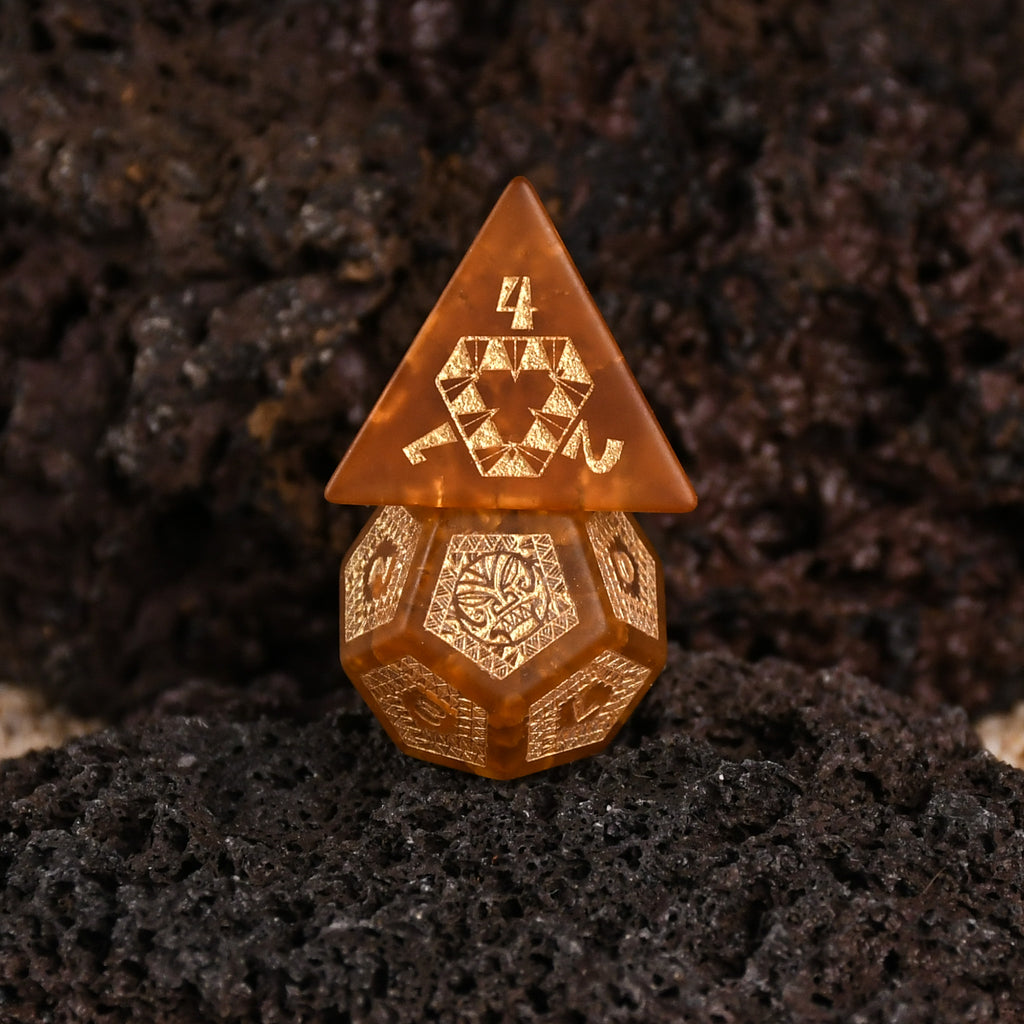 A set of Polynesian Lava Glass dice with Polynesian designs engraved on them.