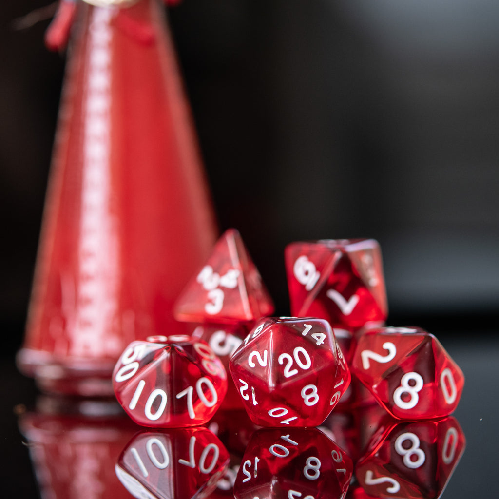 a set of red acrylic dnd dice with white numbers