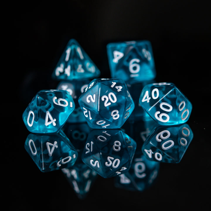 A set of blue acrylic dice with engraved numbers. The dice include a D4, D6, D8, two D10s, D12, and D20.