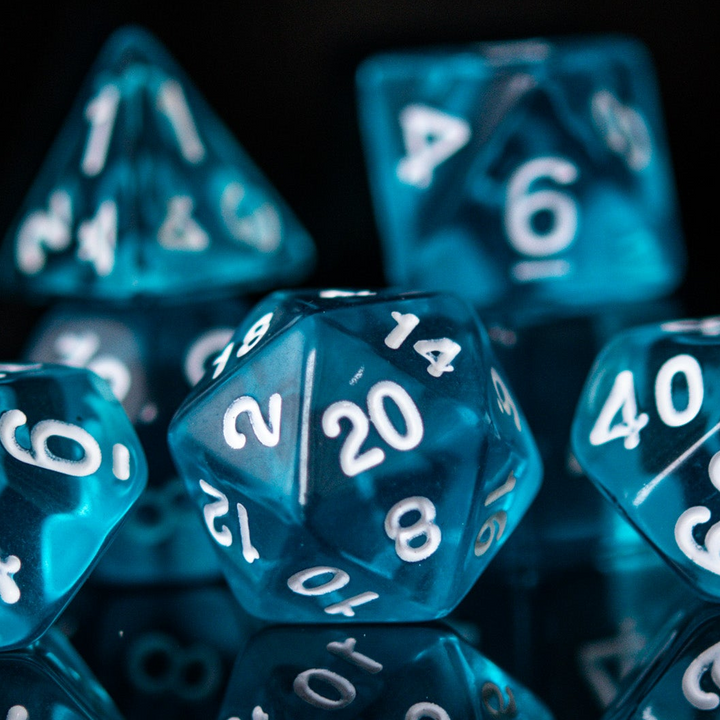 A set of blue acrylic dice with engraved numbers. The dice include a D4, D6, D8, two D10s, D12, and D20.
