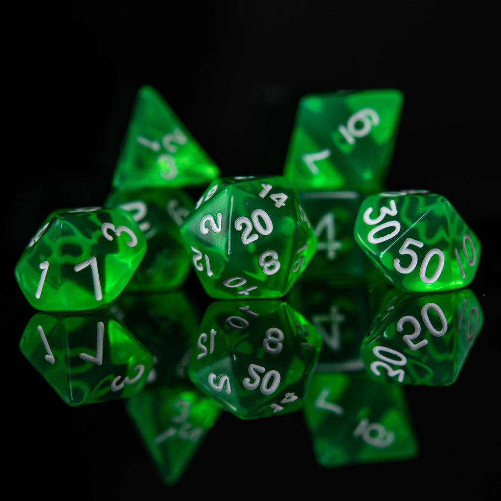 A set of green acrylic dice with engraved numbers. The dice include a D4, D6, D8, two D10s, D12, and D20, arranged on a reflective surface.