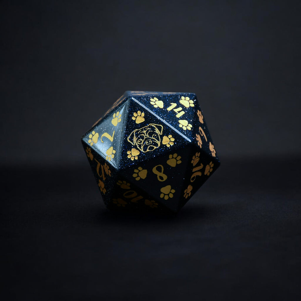 A hand-carved blue sandstone dice with puppy paw designs