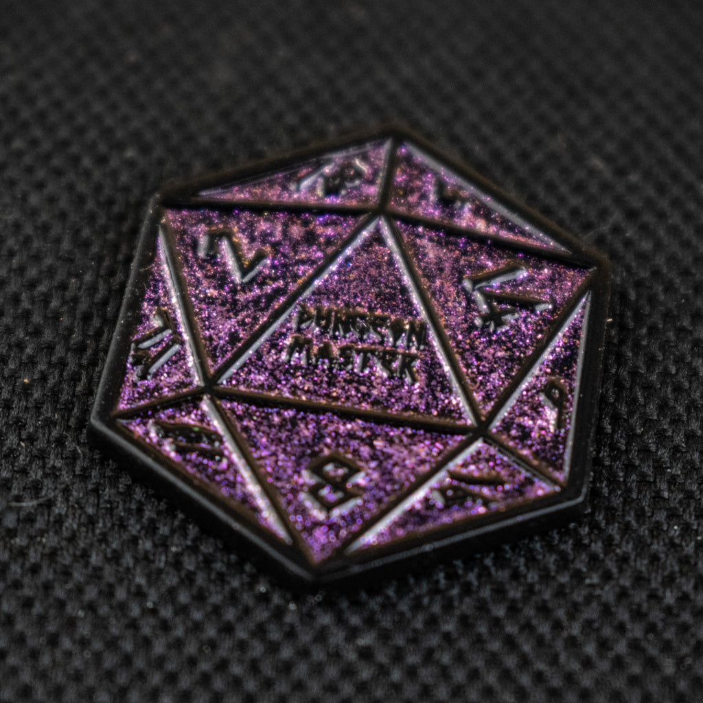 One purple glitter d20 dice pin on a dark background