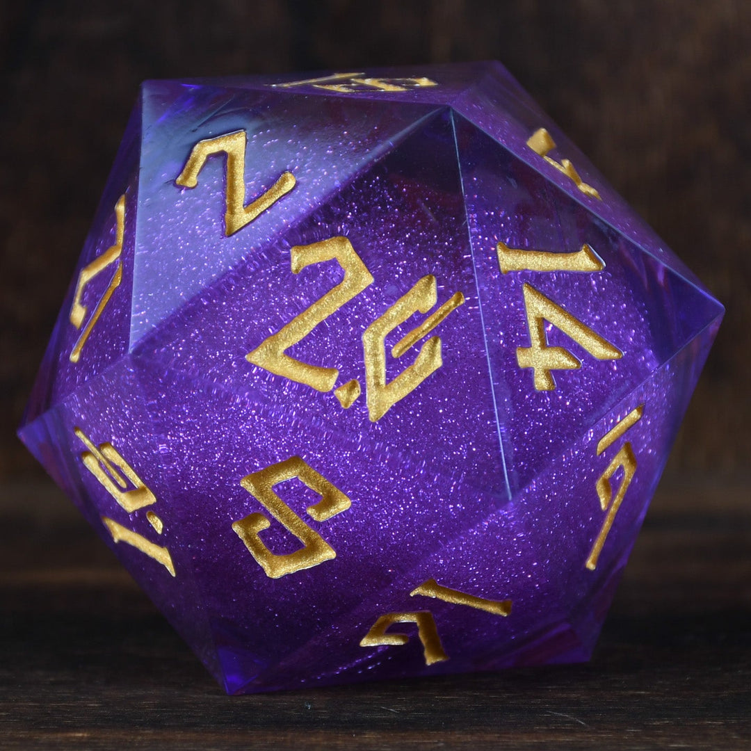 A large, purple, 20-sided die with engraved numbers in gold, surrounded by a wooden backdrop.