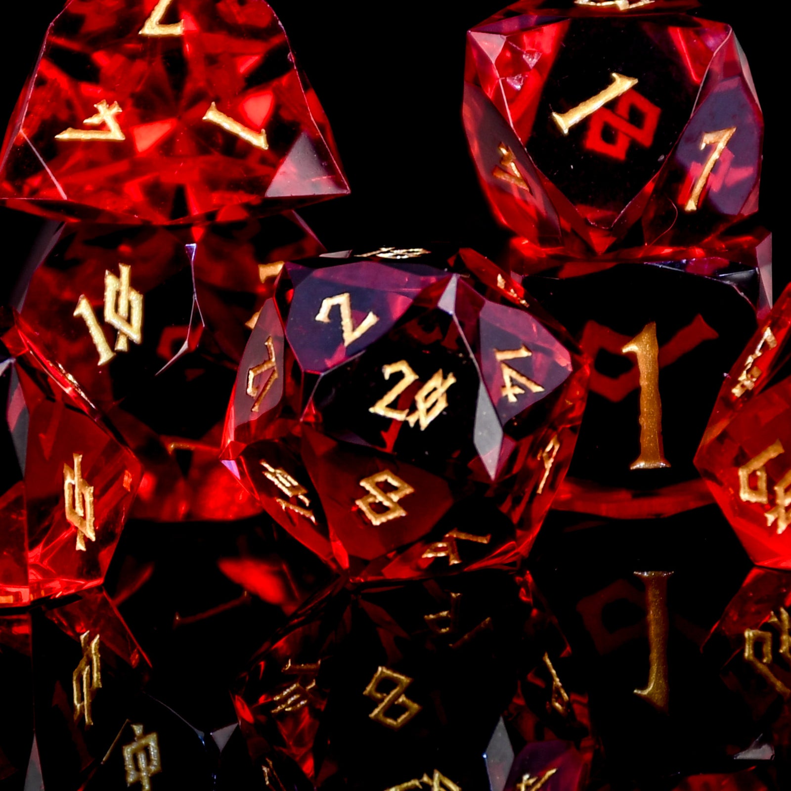 Set of red polyhedral dice with gold numbers on a black background