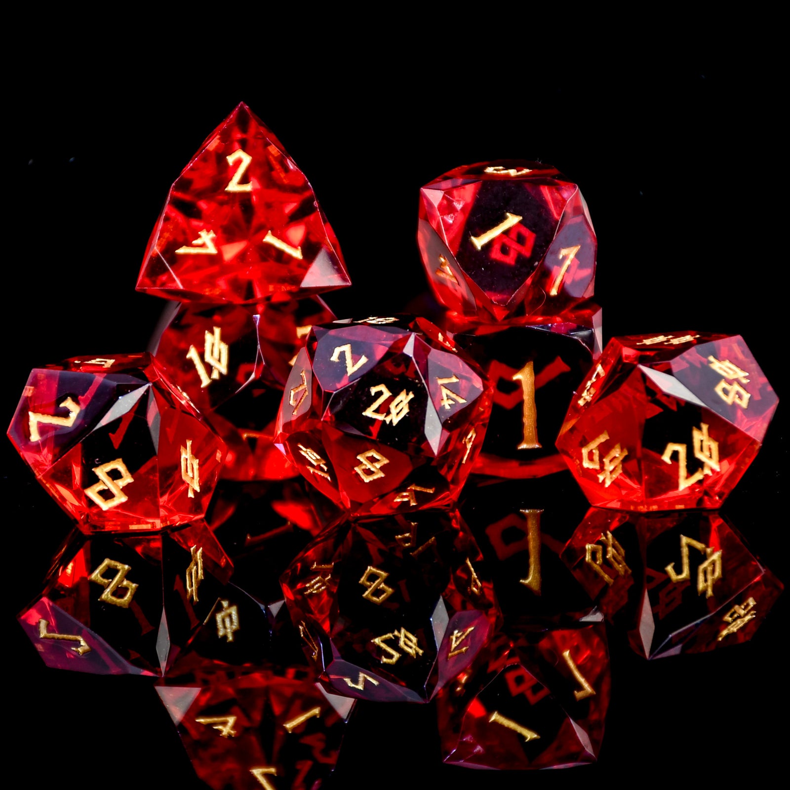 Set of red polyhedral dice with gold numbers on a black background