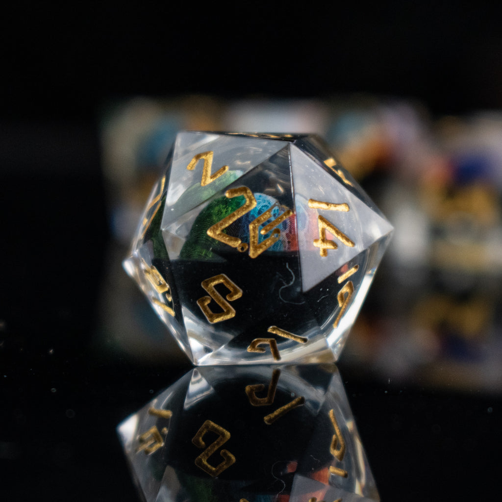 A set of multicolored liquid core resin dice with eye designs inside, displayed on a dark surface.