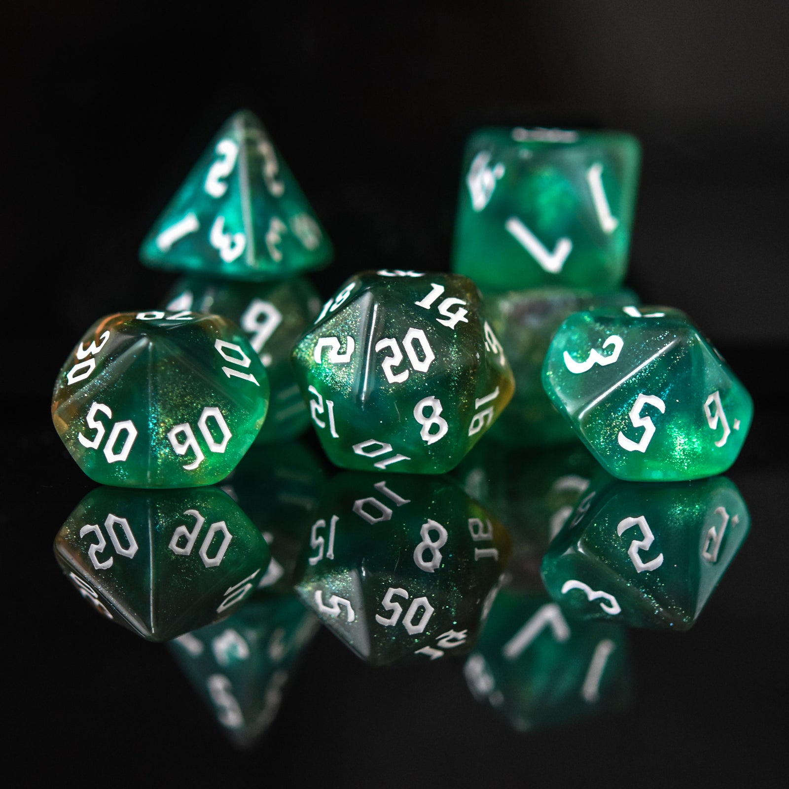 Green polyhedral dice with white numbers on a reflective surface