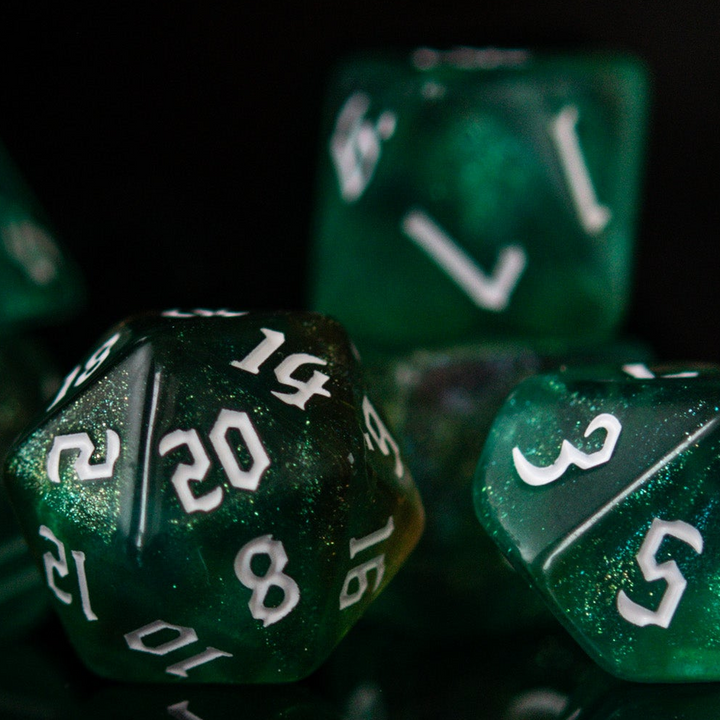 Close-up of green polyhedral dice with white numbers on a black background