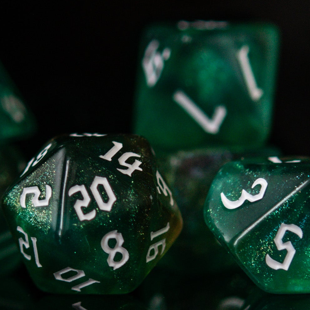 Close-up of green polyhedral dice with white numbers on a black background