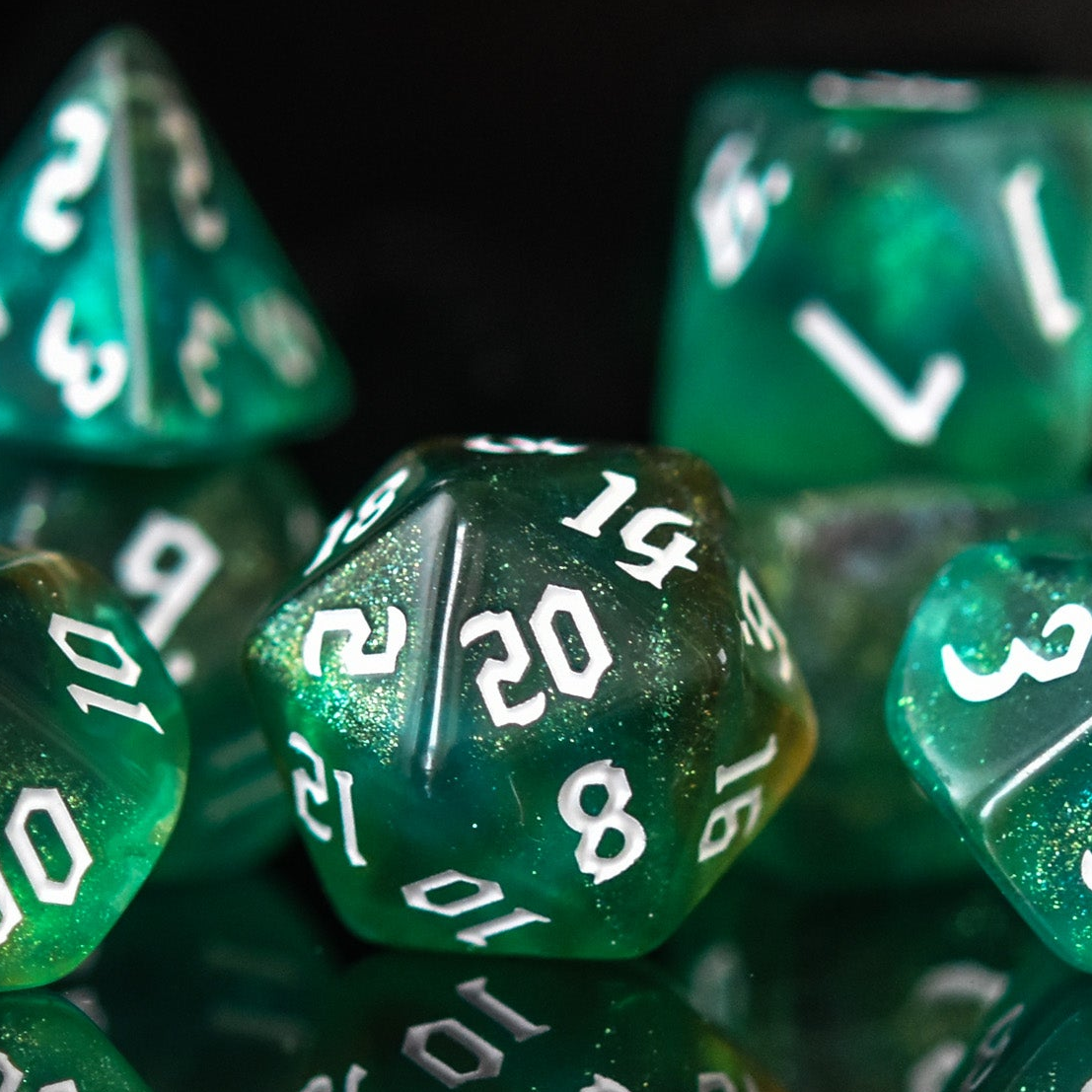 Green polyhedral dice with white numbers on a reflective surface