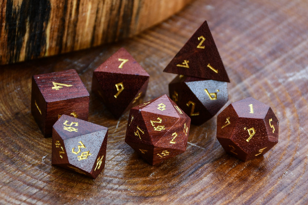 Wooden polyhedral dice set on a wooden surface