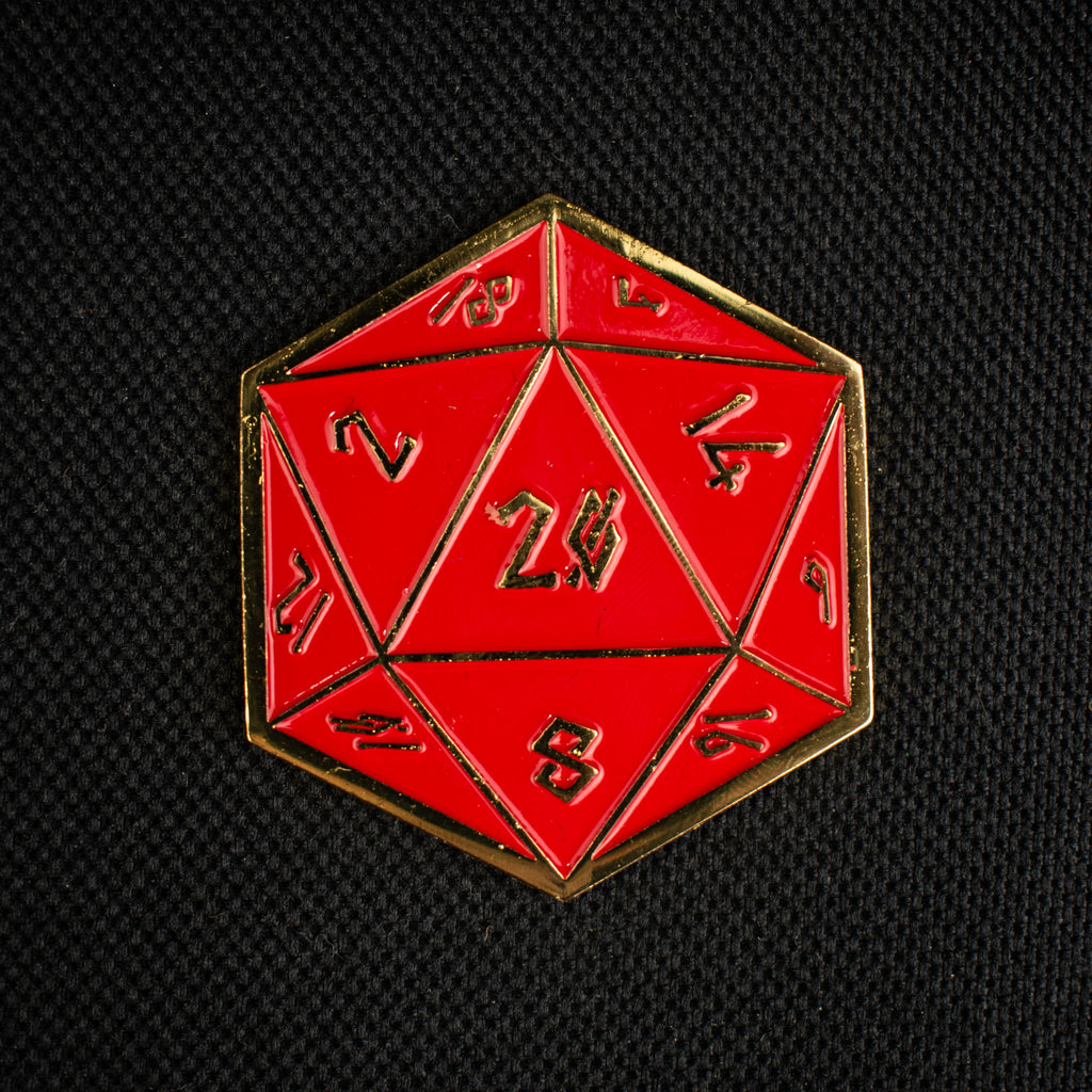 Red polyhedral d20 with gold border on a black background