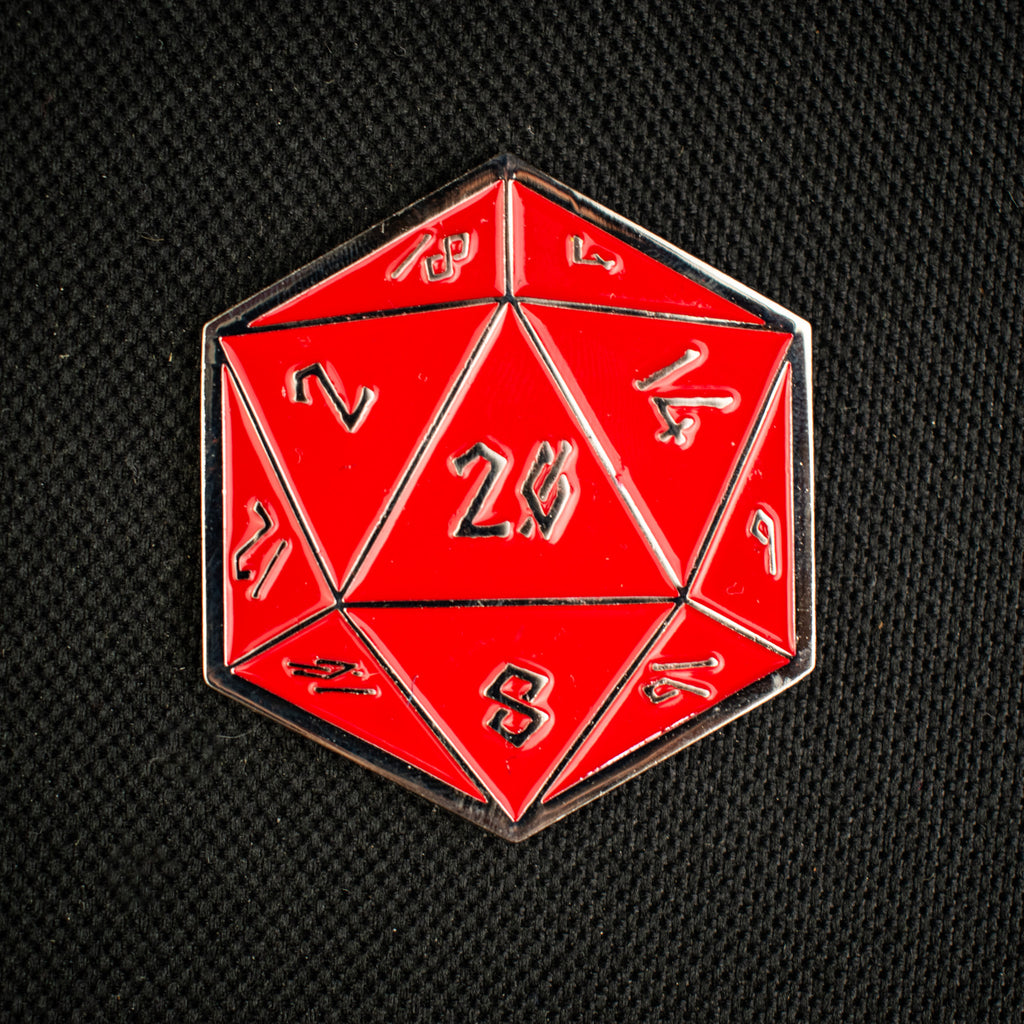 Red polyhedral d20 pin with gold numbers on a black background