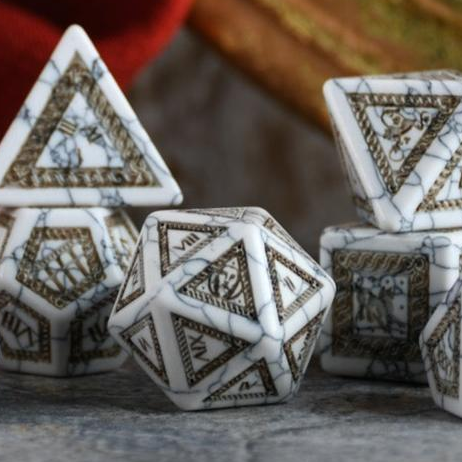 A set of roman inspired white howlite dice with intricate engravings, including a d4, d6, d8, two d10, d12, and d20, displayed on a dark surface.